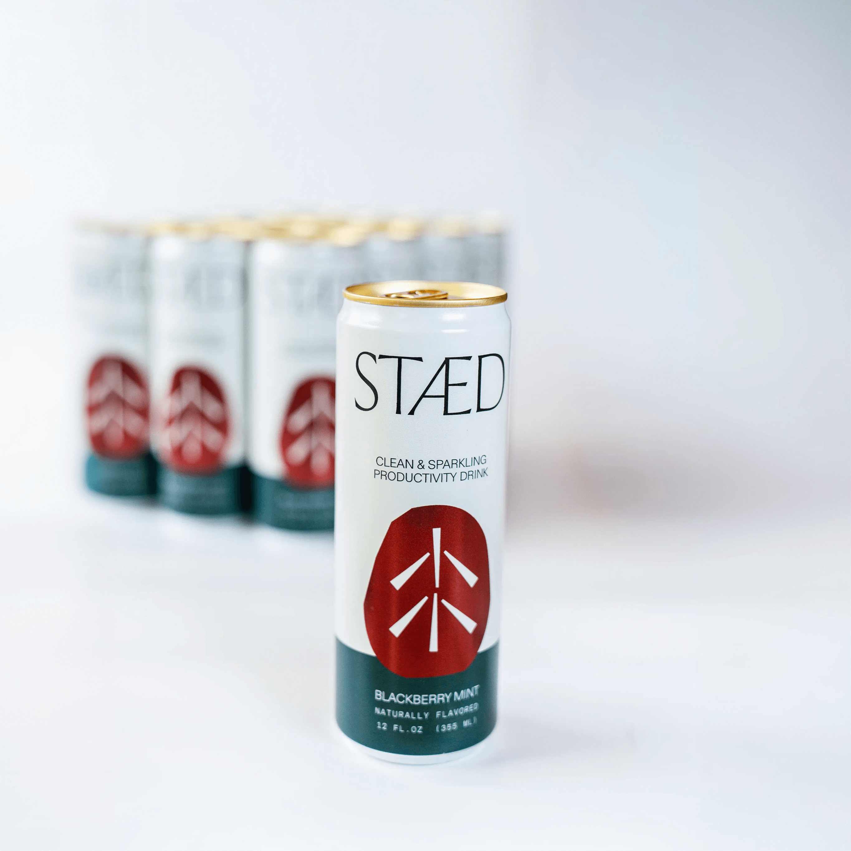 STAÜd energy drink can with red and white logo on a light gray background