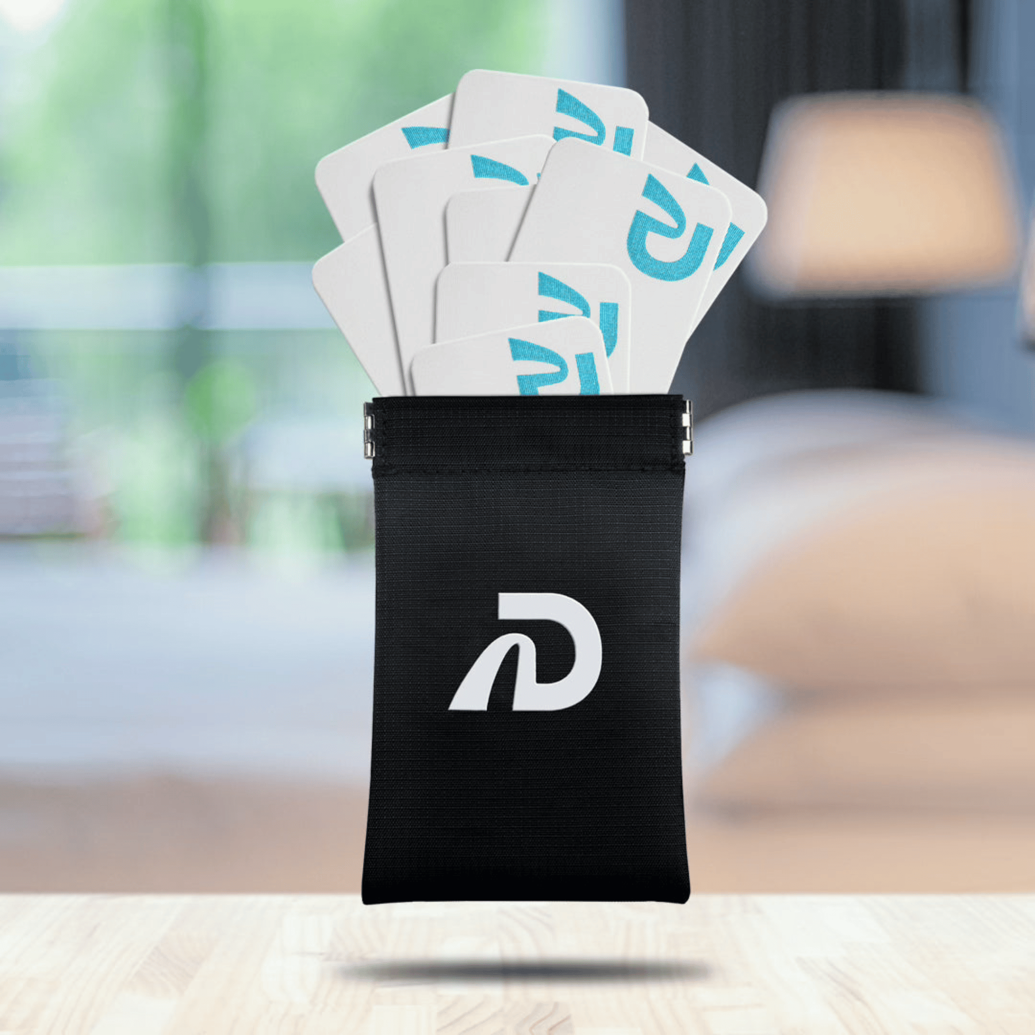A black Dream Tape Storage Pouch with a white logo, displayed in a home environment, presumably holding dream tapes inside.