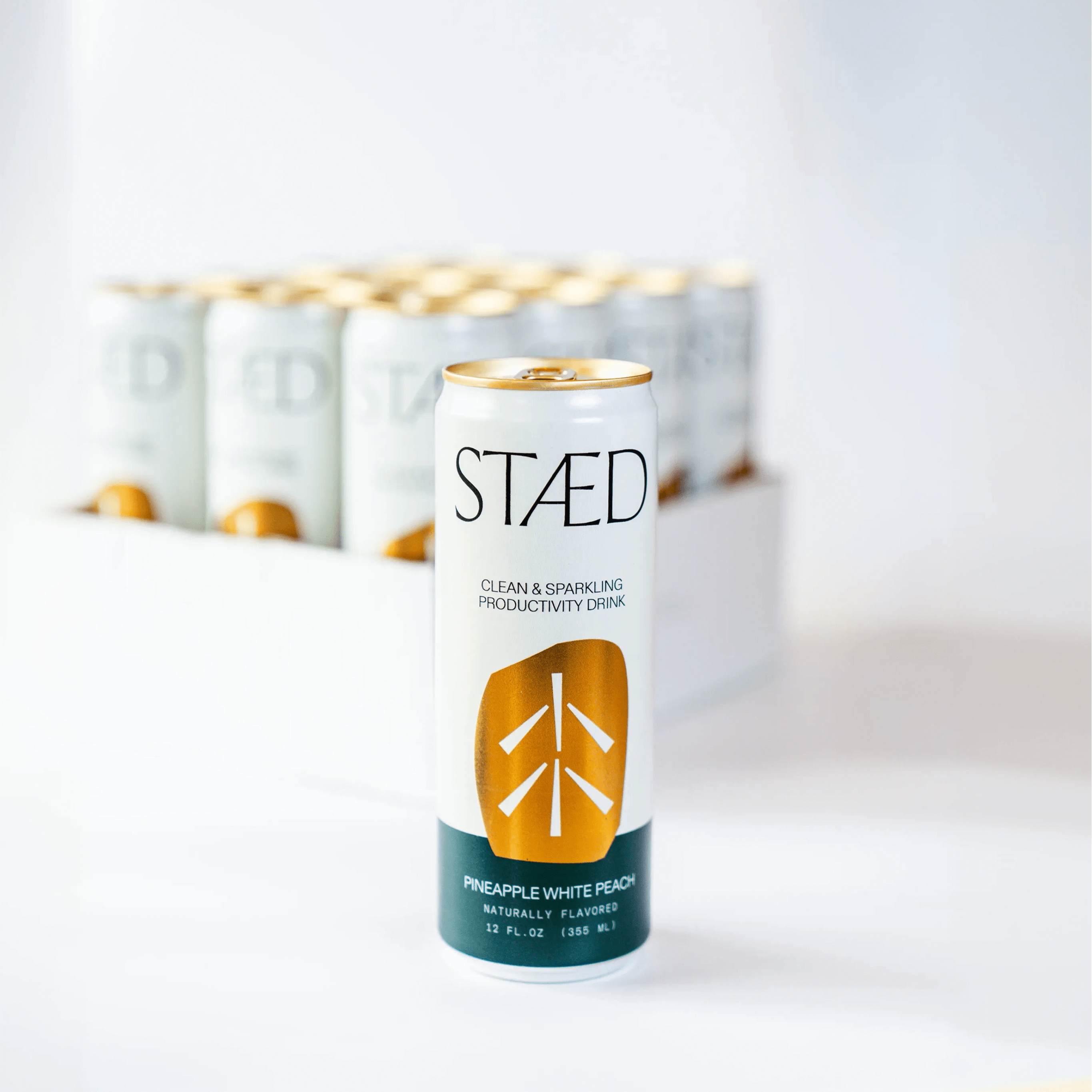 STAÜd can on a white background with more cans stacked in the background