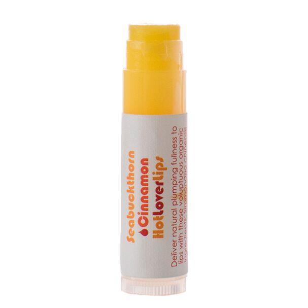 A tube of Seabuckthorn Cinnamon Hot Lover Lips lip balm with a yellow lid and a label that includes the product name and descriptions.