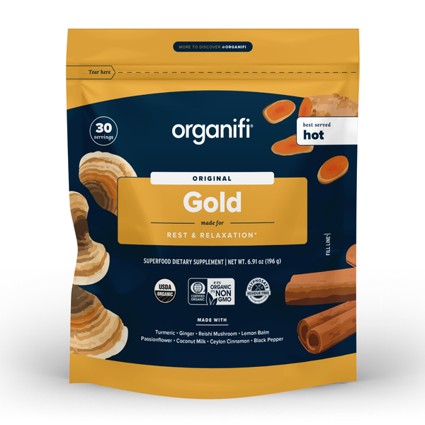 A package of Organifi Gold, a golden-colored herbal supplement powder, with images of mushrooms, lemon, and cinnamon on the package.