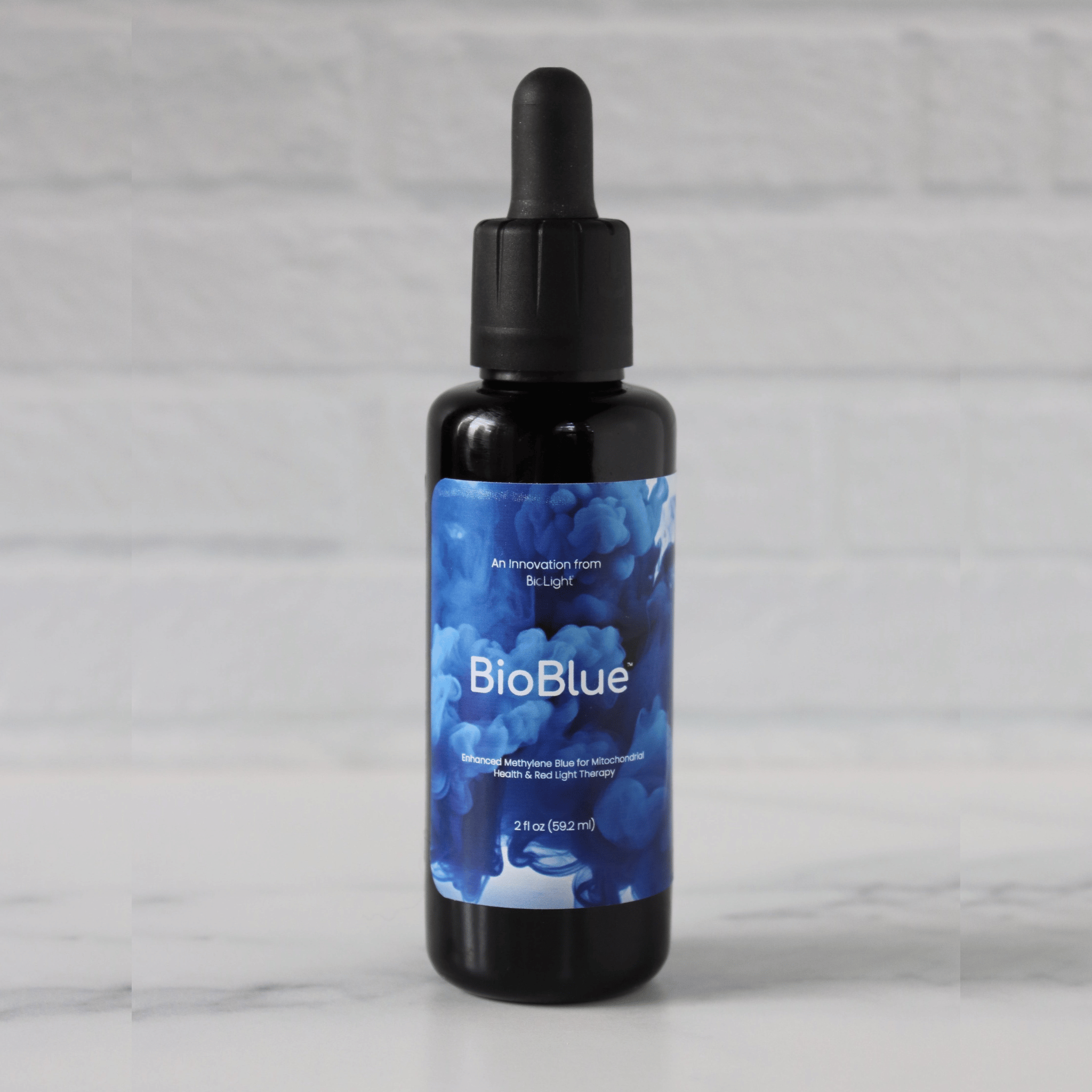 A bottle of BioBlue Methylene Blue Supplement with a dropper, against a white background.