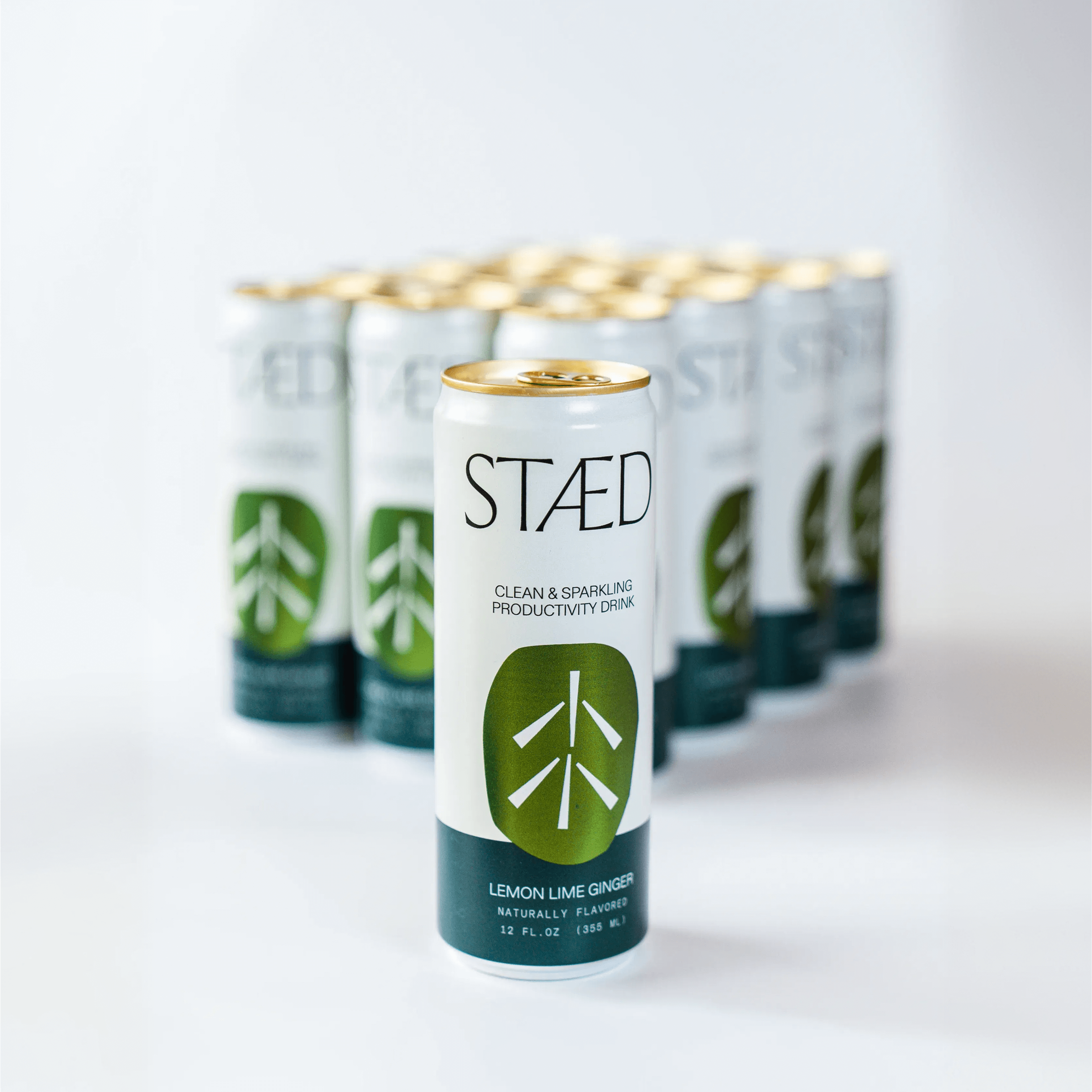 Multiple cans of Staéd drink on a white background