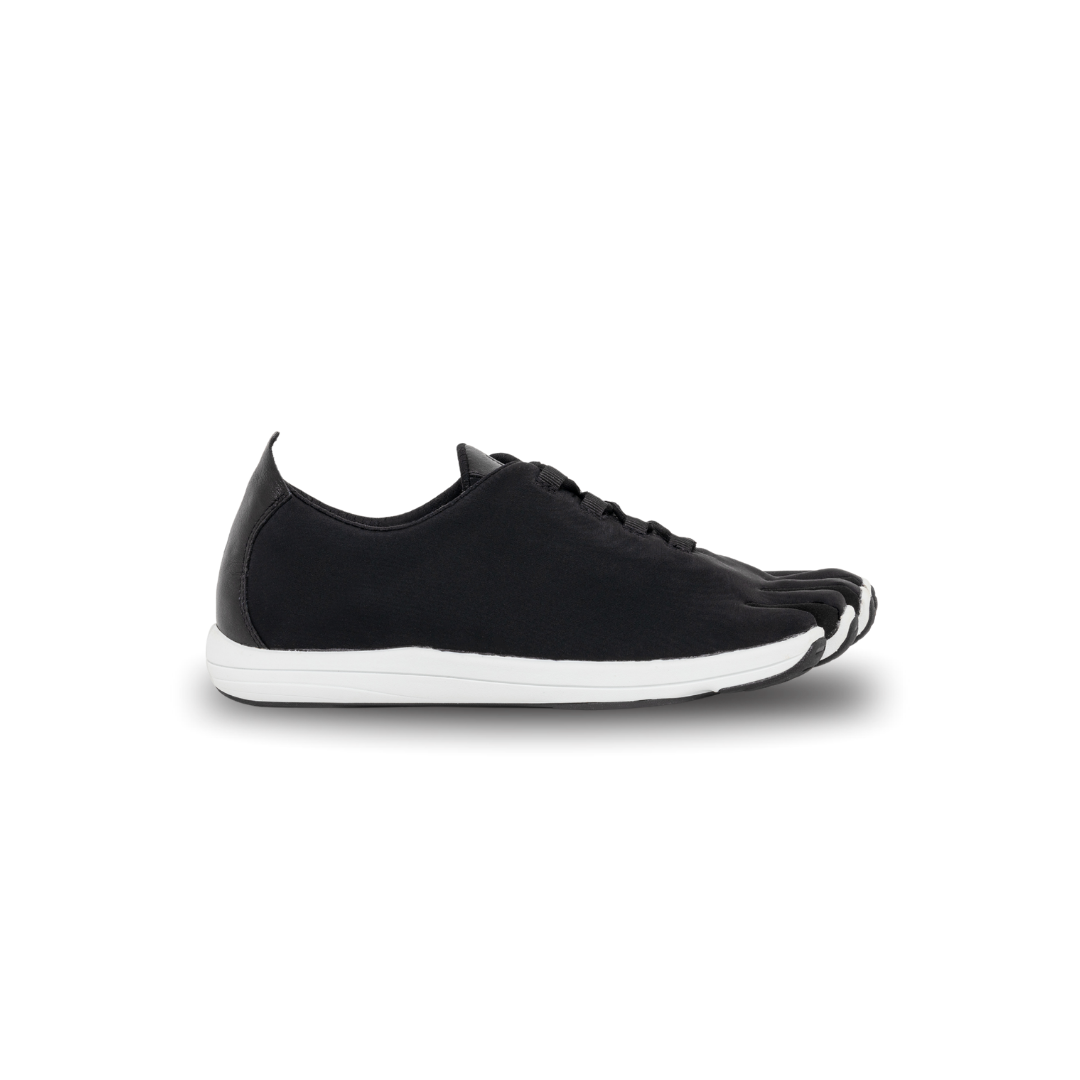 Black sneaker with white sole on a white background